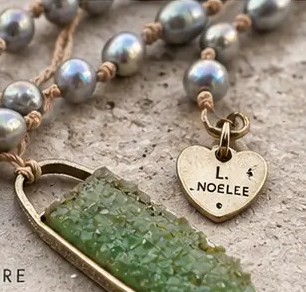 Engraved gold L. Noelle heart signature tag